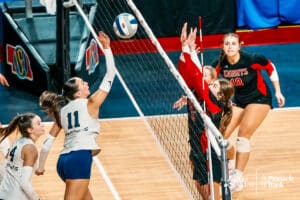 Lincoln Lutheran's Bella Sjuts (11) spikes the ball against Norfolk Catholic during the semi-finals of the 2024 NSAA Volleyball Championships Friday, November 8, 2024, in Lincoln, Nebraska. Photo by Mike Sautter.