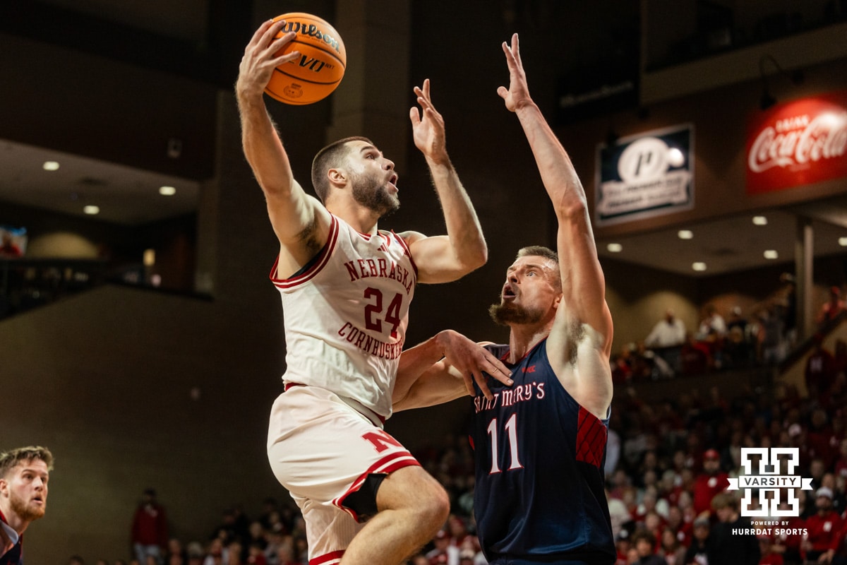 Nebraska Cornhusker guard Rollie Worster (24) makes a layup against St. Mary's Gaels center Mitchell Saxen (11) during a college basketball game Sunday, November 17, 2024 in Sioux Falls, South Dakota.