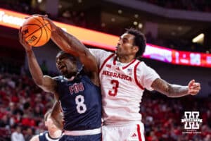 Nebraska Cornhusker guard Brice Williams (3) and Fairleigh Dickinson Knight guard Ahmed Barba-Bey (8) go for a rebound in the first half during a college basketball game Wednesday, November 13, 2024, in Lincoln, Nebraska. Photo by John S. Peterson.