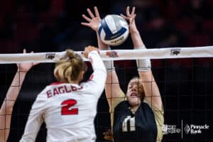 Thayer Central's Ella Brueggemann (11) blocks a spike from Johnson-Brock's Daley Pelican (2) during the semi-finals of the 2024 NSAA Volleyball Championships Friday, November 8, 2024, in Lincoln, Nebraska. Photo by John S. Peterson.