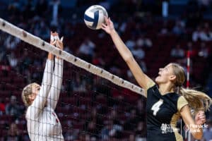 Johnson-Brock's Hannah Groth (4) tips the ball over against Johnson-Brock during the semi-finals of the 2024 NSAA Volleyball Championships Friday, November 8, 2024, in Lincoln, Nebraska. Photo by John S. Peterson.