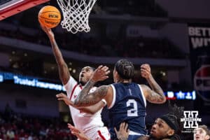 Nebraska Cornhusker guard Ahron Ulis (2) makes a layup against Fairleigh Dickinson Knight guard Terrence Brown (2) in the first half during a college basketball game Wednesday, November 13, 2024, in Lincoln, Nebraska. Photo by John S. Peterson.