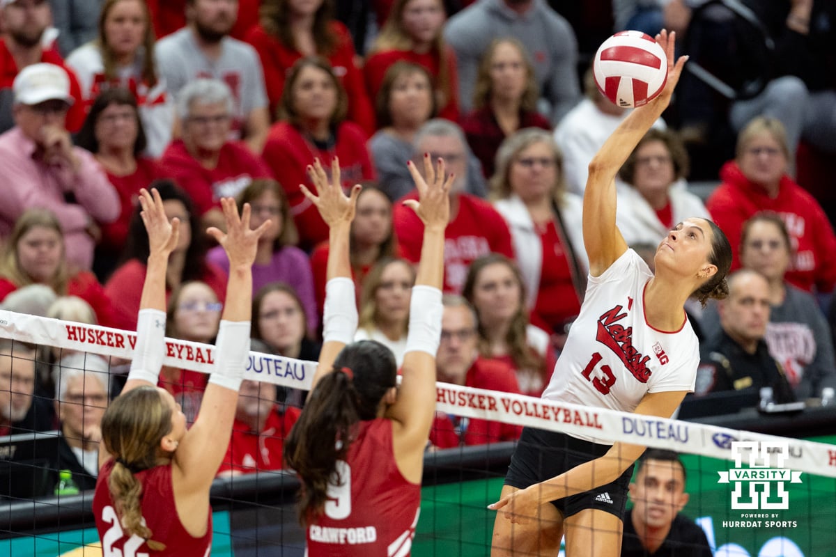 Nebraska Cornhusker outside hitter Merritt Beason (13) spikes the ball against Wisconsin Badger libero Julia Orzol (22) and middle blocker CC Crawford (9) in the second set during a college volleyball match Saturday, November 23, 2024 in Lincoln, Nebraska. Photo by John S. Peterson.