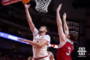 Nebraska Cornhuskers forward Berke Buyuktuncel (9) makes a layup against South Dakota Coyotes guard Max Burchill (3) in the first half during a college basketball game Wednesday, November 27, 2024, in Lincoln, Nebraska. Photo by John S. Peterson.