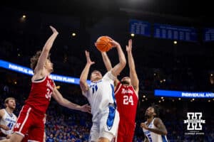 Creighton Bluejay center Ryan Kalkbrenner (11) grabs the rebound against Nebraska Cornhusker guard Rollie Worster (24) and center Braxton Meah (34) in the second half during a college basketball game Friday, November 22, 2024 in Omaha, Nebraska. Photo by John S. Peterson.