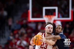 Nebraska Cornhusker forward Andrew Morgan (23) keeps the ball away from Fairleigh Dickinson Knight forward Cameron Tweedy (21) in the second half during a college basketball game Wednesday, November 13, 2024, in Lincoln, Nebraska. Photo by John S. Peterson.