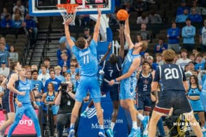 Isaac Traudt blocks a shot during a college basketball game November 10th, 2024 in Omaha Nebraska. Photo by Brandon Tiedemann.