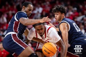 Nebraska Cornhusker guard Ahron Ulis (2) drives through Fairleigh Dickinson Knight forward Cameron Tweedy (21) and forward Jo'el Emanuel (13) during a college basketball game Wednesday, November 13, 2024, in Lincoln, Nebraska. Photo by John S. Peterson.