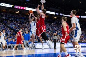 Creighton Bluejay guard Pop Isaacs (2) drives to the basket against Nebraska Cornhusker forward Andrew Morgan (23) and guard Brice Williams (3) in the second half during a college basketball game Friday, November 22, 2024 in Omaha, Nebraska. Photo by John S. Peterson.