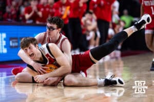 South Dakota Coyotes forward Jake Brack (21) holds on to the ball againt Nebraska Cornhuskers guard Gavin Griffiths (12) in the second half during a college basketball game Wednesday, November 27, 2024, in Lincoln, Nebraska. Photo by John S. Peterson.