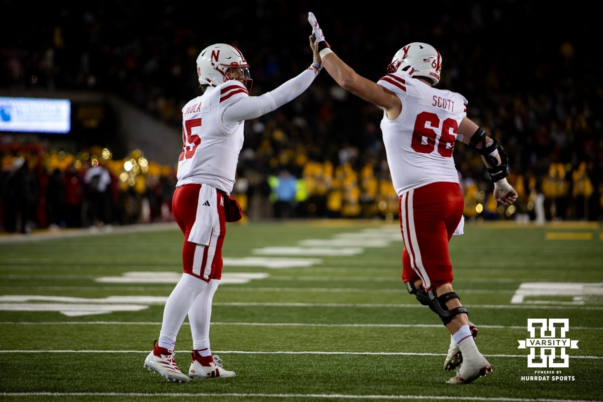 Nebraska Cornhuskers quarterback Dylan Raiola (15) gives a high five with Nebraska Cornhuskers offensive lineman Ben Scott (66) against the Iowa Hawkeyes during a college football game Friday, November 29, 2024, in Iowa City, Iowa. Photo by John S. Peterson.