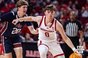 Nebraska Cornhusker guard Connor Essegian (0) dribbles the ball against Fairleigh Dickinson Knight guard Dylan Jones (20) in the second half during a college basketball game Wednesday, November 13, 2024, in Lincoln, Nebraska. Photo by John S. Peterson.