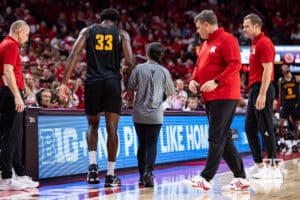 Bethune-Cookman Wildcat trainer help center David Onanina (33) back to the bench against the Nebraska Cornhuskers during a college baskteball game Saturday, November 9, 2024, in Lincoln, Nebraska. Photo by John S. Peterson.