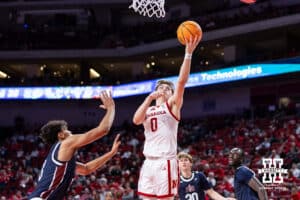 Nebraska Cornhusker guard Connor Essegian (0) makes a layup against Fairleigh Dickinson Knight forward Jo'el Emanuel (13) in the second half during a college basketball game Wednesday, November 13, 2024, in Lincoln, Nebraska. Photo by John S. Peterson.