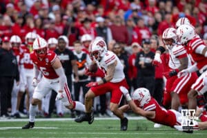 Nebraska Cornhusker defensive back Isaac Gifford (2) grabs on to trying to tackle Wisconsin Badger wide receiver Trech Kekahuna (2) in the second quarter during a college football game Saturday, November 23, 2024 in Lincoln, Nebraska. Photo by John S. Peterson.