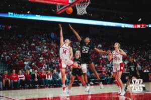 Callin Hake (14) shoots the ball while India Howard (22) plays defense during a college basketball game Tuesday, November 19, 2024, in Lincoln, Nebraska. Photo by Charlotte A. Gottfried.