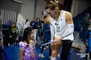 Creighton Bluejay outside hitter Norah Sis (2) signs an autographh after the win over St. John's Red Storm during a college volleyball match Friday, November 1, 2024, in Omaha, Nebraska. Photo by John S. Peterson.