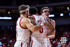 Nebraska Cornhusker guard Jeffrey Grace III (8) celebrates a basket with guard Sam Hoiberg (1) and guard Gavin Griffiths (12) in the second half during a college basketball game Wednesday, November 13, 2024, in Lincoln, Nebraska. Photo by John S. Peterson.