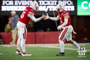 Nebraska Cornhusker quarterback Dylan Raiola (15) gives linebacker John Bullock (5) five while coming off the field against the Wisconsin Badgers during a college football game Saturday, November 23, 2024 in Lincoln, Nebraska. Photo by John S. Peterson.