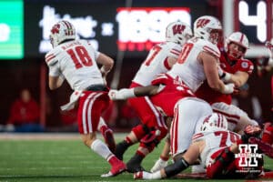 isconsin Badger quarterback Braedyn Locke (18) tries to get away from Nebraska Cornhusker linebacker Princewill Umanmielen (18) during a college football game Saturday, November 23, 2024 in Lincoln, Nebraska. Photo by John S. Peterson.