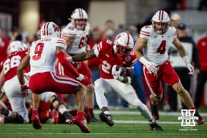 Nebraska Cornhusker running back Emmett Johnson (21) runs the ball against Wisconsin Badger safety Austin Brown (9) during a college football game Saturday, November 23, 2024 in Lincoln, Nebraska. Photo by John S. Peterson.