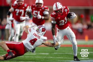 Nebraska Cornhusker running back Emmett Johnson (21) runs the ball against Wisconsin Badger linebacker Tackett Curtis (4) in the fourth quarter during a college football game Saturday, November 23, 2024 in Lincoln, Nebraska. Photo by John S. Peterson.