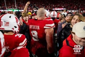 Nebraska Cornhusker defensive lineman Ty Robinson (9) makes his way through all the students that stormed the field after the win over the Wisconsin Badgers during a college football game Saturday, November 23, 2024 in Lincoln, Nebraska. Photo by John S. Peterson.