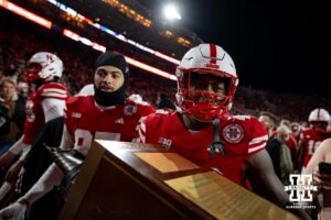 Nebraska Cornhusker linebacker Mikai Gbayor (42) carries the Freedom Trophy to the locker room after the win over the Wisconsin Badgers during a college football game Saturday, November 23, 2024 in Lincoln, Nebraska. Photo by John S. Peterson.