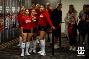 Nebraska Cornhuskers waiting for the first match between Texas A&M and Wisconsin to start warming up to take on the Dayton Flyers during the first regional match in the NCAA championship Friday, December 13, 2024, in Lincoln, Nebraska. Photo by John S. Peterson.