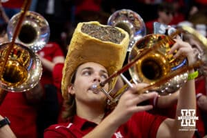 Nebraska Cornhuskers trombone player wearing a Runza hat wihile playing during the final regional match against the Wisconsin Badgers in the NCAA championship Sunday, December 15, 2024, in Lincoln, Nebraska. Photo by John S. Peterson.