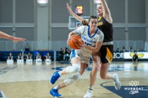 Creighton Bluejays Lauren Jensen drives to the hoop during a college basketball game against the Wyoming Cowgirls on December 17th, 2024 in Omaha Nebraska. Photo by Brandon Tiedemann.