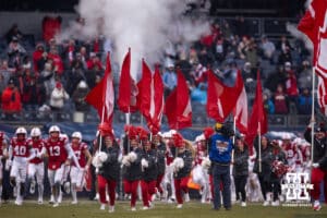 Nebraska Cornhuskers cheer squad lead the Huskers out to the field during the Pinstripe Bowl game, Saturday, December 28, 2024, in New York, New York. Photo by John S. Peterson.