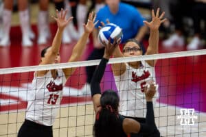 Nebraska Cornhuskers middle blocker Rebekah Allick (5) and outside hitter Merritt Beason (13) jump to block a shot from the Miami Hurricanes in the first set during the second round of the NCAA volleyball tournament Saturday, December 7, 2024, in Lincoln, Nebraska. Photo by John S. Peterson.