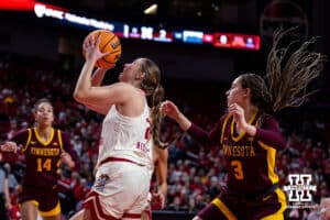 Nebraska Cornhuskers guard Logan Nissley (2) drives to the basket for a lay up against Minnesota Golden Gophers guard Amaya Battle (3) in the first quarter during a college basketball game Sunday, December 8, 2024, in Lincoln, Nebraska. Photo by John S. Peterson.