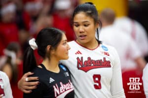 Nebraska Cornhuskers setter Kennedi Orr (9) gives Lexi Rodriguez a hug waiting for introductions against the Dayton Flyers during the first regional match in the NCAA championship Friday, December 13, 2024, in Lincoln, Nebraska. Photo by John S. Peterson.