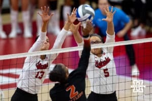 Nebraska Cornhuskers outside hitter Merritt Beason (13) and middle blocker Rebekah Allick (5) attempt to block Florida A&M Rattlers outside hitter Brooke Lynn Watts (2) in the first set during the first round of the NCAA volleyball tournament Friday, December 6, 2024, in Lincoln, Nebraska. Photo by John S. Peterson.