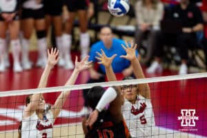 Nebraska Cornhuskers middle blocker Rebekah Allick (5) and Nebraska Cornhuskers setter Bergen Reilly (2) jump to block at shot from Miami Hurricanes outside hitter Flormarie Heredia Colon (10) in the first set during the second round of the NCAA volleyball tournament Saturday, December 7, 2024, in Lincoln, Nebraska. Photo by John S. Peterson.