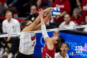 Nebraska Cornhuskers middle blocker Rebekah Allick (5) stuffs Wisconsin Badgers setter Charlie Fuerbringer (24) in the first set during the final regional match in the NCAA championship Sunday, December 15, 2024, in Lincoln, Nebraska. Photo by John S. Peterson.