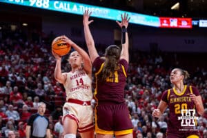 Nebraska Cornhuskers guard Callin Hake (14) makes a lay up against Minnesota Golden Gophers forward Annika Stewart (21) in the first half during a college basketball game Sunday, December 8, 2024, in Lincoln, Nebraska. Photo by John S. Peterson.