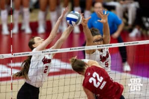 Nebraska Cornhuskers setter Bergen Reilly (2) with Rebekah Allick blocks a spike from Wisconsin Badgers libero Julia Orzol (22) in the first set during the final regional match in the NCAA championship Sunday, December 15, 2024, in Lincoln, Nebraska. Photo by John S. Peterson.