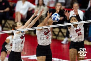 Nebraska Cornhuskers middle blocker Rebekah Allick (5) blocks a shot from the Wisconsin Badgers with Bergen Reilly and Taylor Landfair in the first set during the final regional match in the NCAA championship Sunday, December 15, 2024, in Lincoln, Nebraska. Photo by John S. Peterson.