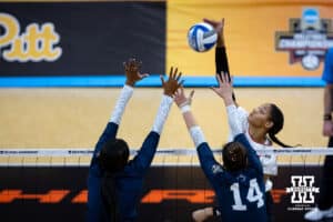 Nebraska Cornhuskers outside hitter Taylor Landfair (12) spikes the ball against the Penn State Nittany Lions during the semi-final round in the NCAA championship Thursday, December 19, 2024, in Louisville, Kentucky. Photo by John S. Peterson.