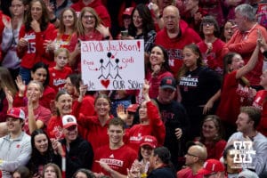 Nebraska Cornhuskers middle blocker Andi Jackson's (15) sisters holding up a sign during the final regional match against the Wisconsin Badgers in the NCAA championship Sunday, December 15, 2024, in Lincoln, Nebraska. Photo by John S. Peterson.