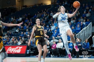 Creighton Bluejays Morgan Maly attempts a layup during a college basketball game against the Wyoming Cowgirls on December 17th, 2024 in Omaha Nebraska. Photo by Brandon Tiedemann.