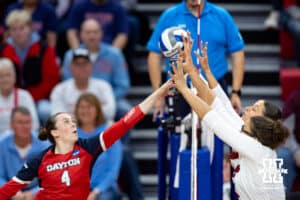 Nebraska Cornhuskers middle blocker Rebekah Allick (5) and outside hitter Merritt Beason (13) blocks a hit from Dayton Flyers outside hitter Lexie Almodovar (4) in the first set during the first regional match in the NCAA championship Friday, December 13, 2024, in Lincoln, Nebraska. Photo by John S. Peterson.