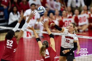 Nebraska Cornhuskers middle blocker Andi Jackson (15) spikes the ball against Wisconsin Badgers middle blocker Carter Booth (52) and Wisconsin Badgers opposite Anna Smrek (14) in the first set during the final regional match in the NCAA championship Sunday, December 15, 2024, in Lincoln, Nebraska. Photo by John S. Peterson.