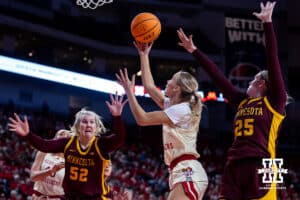 Nebraska Cornhuskers guard Alberte Rimdal (5) makes a lay up against Minnesota Golden Gophers center Sophie Hart (52) and guard Grace Grocholski (25) in the first half during a college basketball game Sunday, December 8, 2024, in Lincoln, Nebraska. Photo by John S. Peterson.