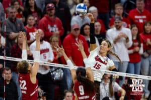 Nebraska Cornhuskers middle blocker Andi Jackson (15) spikes the ball against Wisconsin Badgers libero Julia Orzol (22) and middle blocker CC Crawford (9) in the first set during the final regional match in the NCAA championship Sunday, December 15, 2024, in Lincoln, Nebraska. Photo by John S. Peterson.