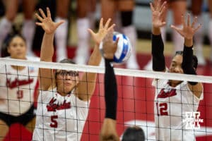 Nebraska Cornhuskers middle blocker Rebekah Allick (5) and outside hitter Taylor Landfair (12) jump up to block a shot against the Miami Hurricanes during the second round of the NCAA volleyball tournament Saturday, December 7, 2024, in Lincoln, Nebraska. Photo by John S. Peterson.