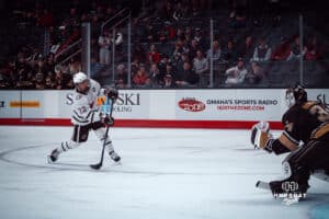 UNO Mavericks player, Jimmy Glynn, makes a shot at the goal during a college hockey game on Dec 29, 2024 in Omaha, Nebraska. Photo by Logan Hock